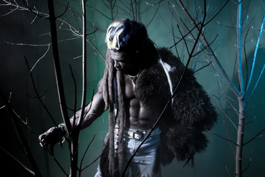 Muscular werewolf among the branches of the tree. Gothic image of scary diabolical creatures for Halloween